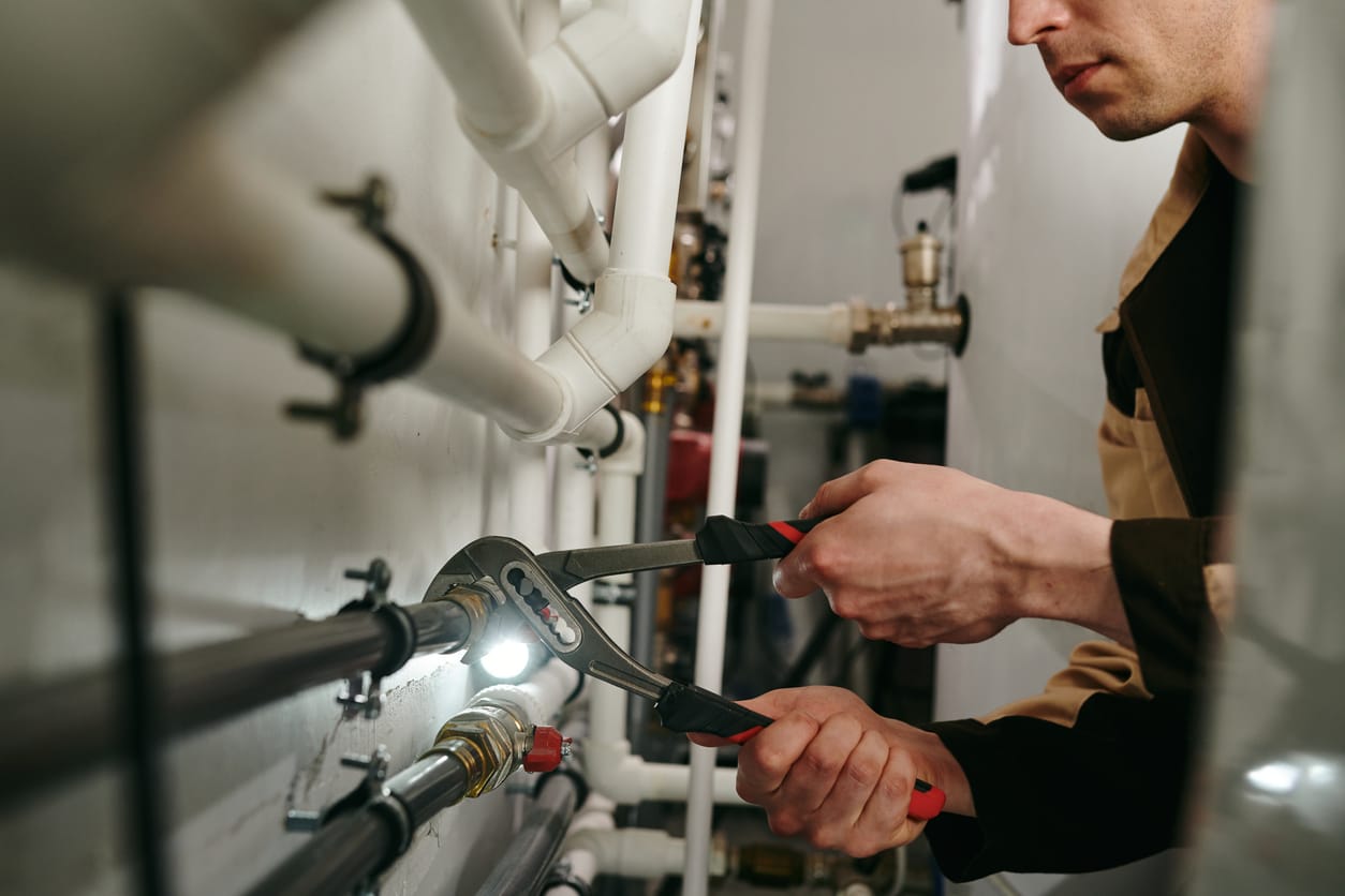 Plumbers maintaining commercial plumbing pipes in Coral Gables