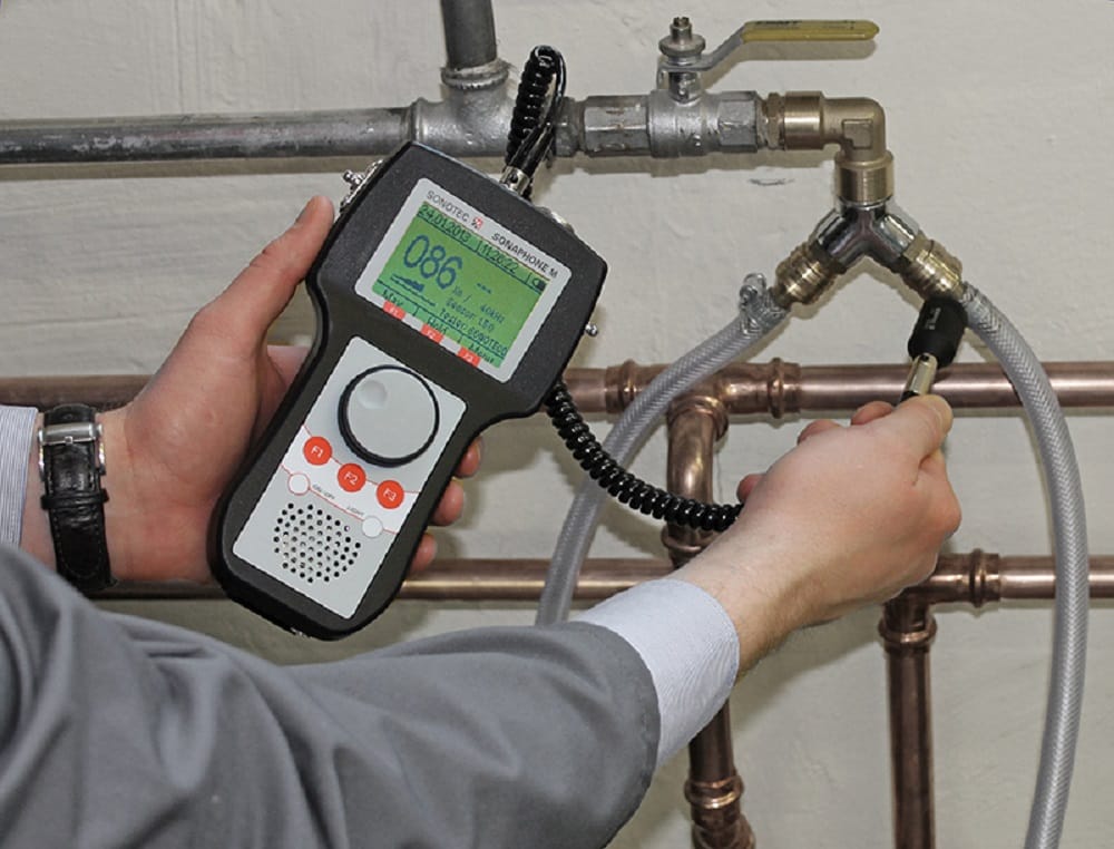 Plumber testing pipes with electronic leak detection equipment in Coral Gables