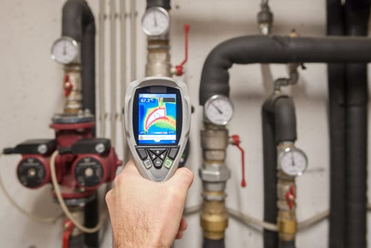 Plumber using a thermal imaging camera to inspect pipes in Coral Gables
