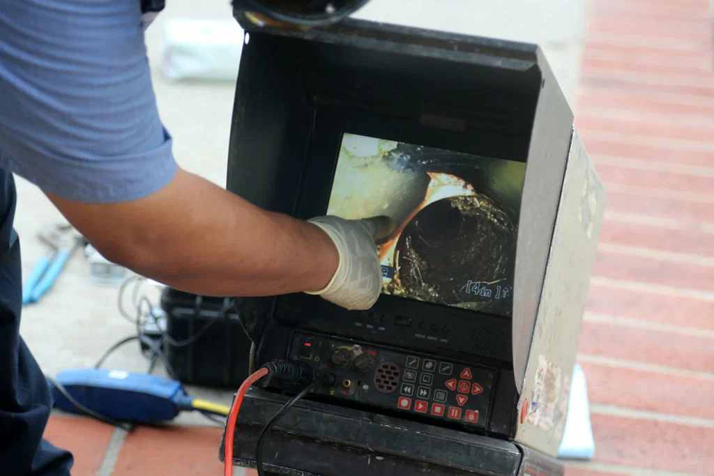 Technician viewing a drain inspection camera in Coral Gables