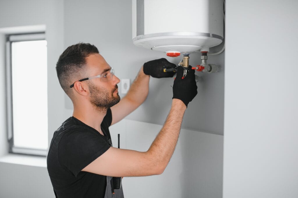 Technician performing water heater maintenance in Coral Gables